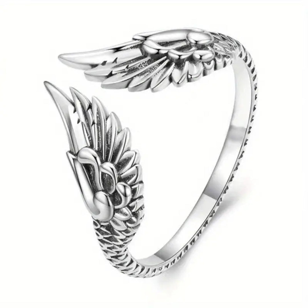 Close-up of an adjustable silver-plated ring featuring intricate carvings and a unique wing-inspired design, ideal for adding elegance to any look.