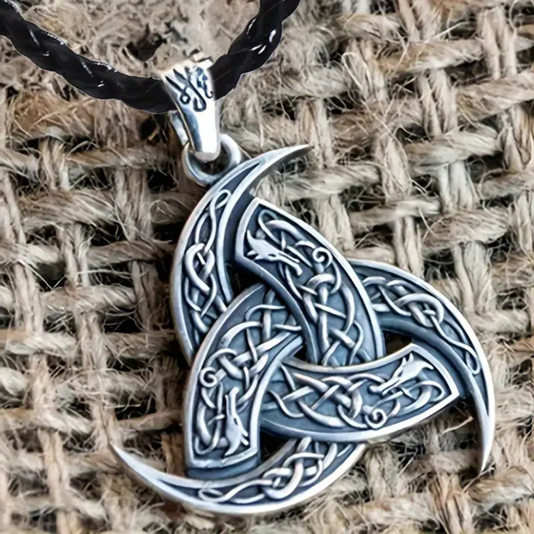 Close-up of a Viking-inspired amulet pendant featuring intricate knotwork, paired with a sleek black faux leather necklace for men.